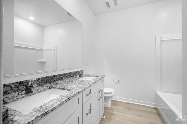 4912 Beaverhead Ave, Bakersfield, CA 93306 - bathroom with wood finished floors, double vanity, and recessed lighting