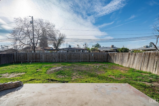 view of yard with a patio and a fenced backyard