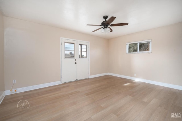 empty room featuring light wood-type flooring, baseboards, and ceiling fan