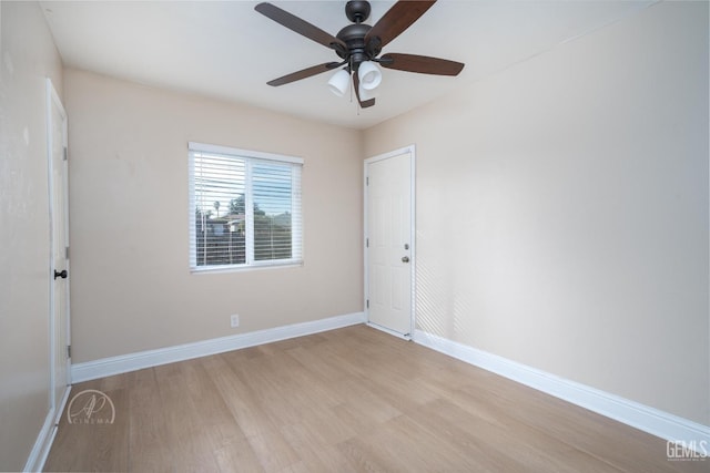 unfurnished room with baseboards, light wood-style floors, and a ceiling fan