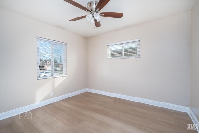 empty room with light wood-style flooring, a ceiling fan, and baseboards