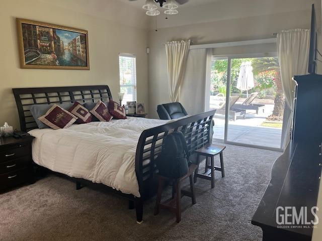 bedroom with access to exterior, multiple windows, ceiling fan, and carpet floors