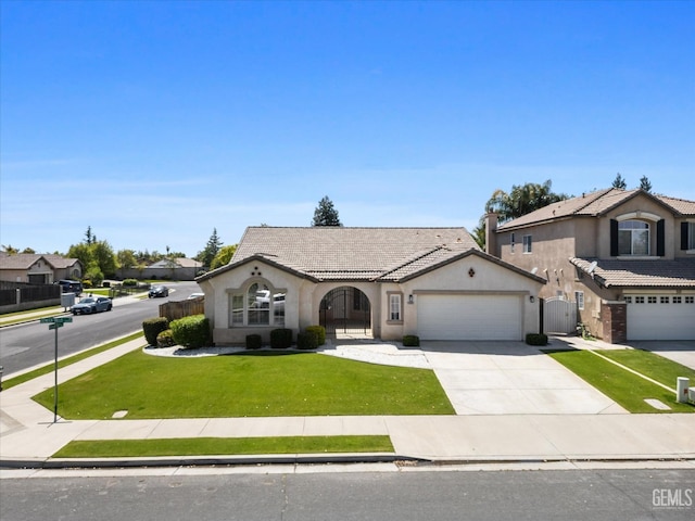 view of front of property with a tiled roof, stucco siding, a front yard, fence, and a garage
