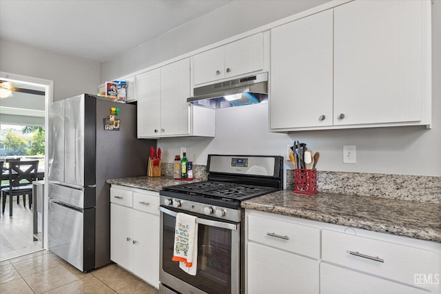 295 Walnut St, Shafter, CA 93263 - kitchen with stainless steel appliances, under cabinet range hood, white cabinets, and light tile patterned floors
