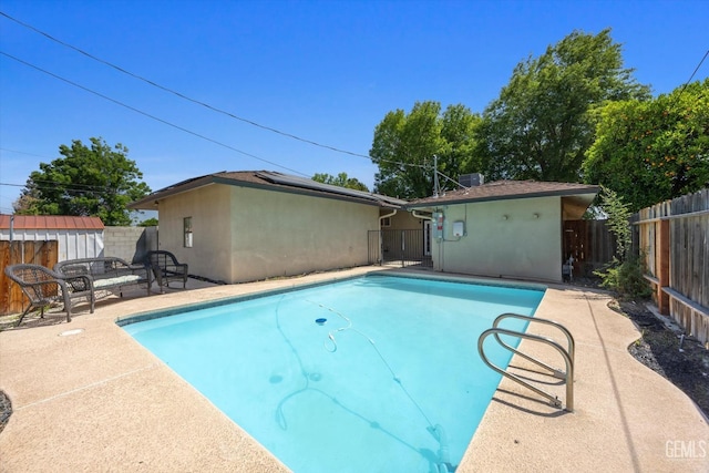 295 Walnut St, Shafter, CA 93263 - view of swimming pool featuring a fenced backyard, a patio area, a shed, and an outdoor structure