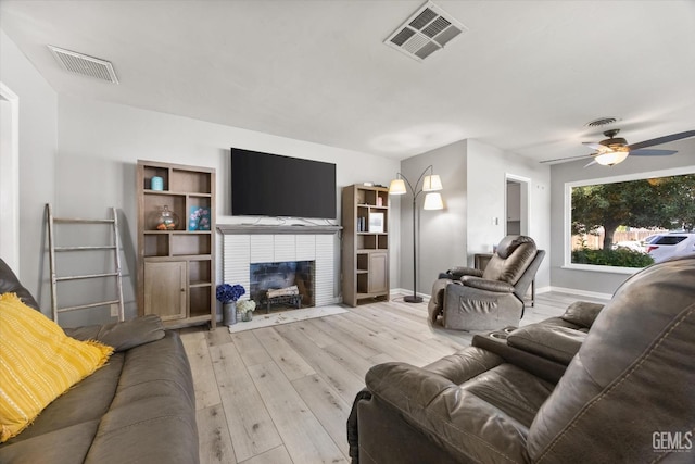 295 Walnut St, Shafter, CA 93263 - living area featuring wood finished floors, a ceiling fan, a fireplace, and baseboards