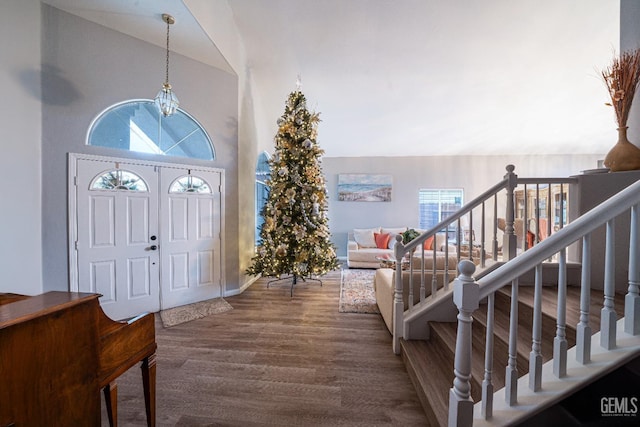 entrance foyer featuring hardwood / wood-style floors and high vaulted ceiling