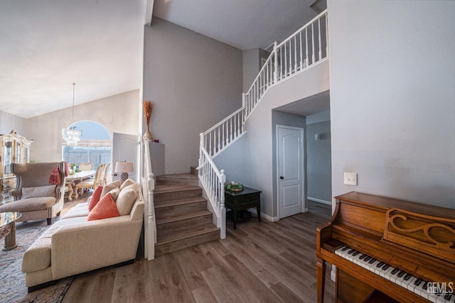 interior space with hardwood / wood-style floors, a high ceiling, and an inviting chandelier