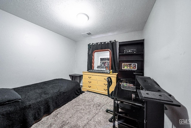 bedroom featuring carpet and a textured ceiling