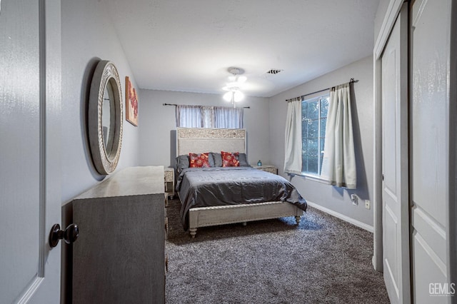 carpeted bedroom with multiple windows and ceiling fan