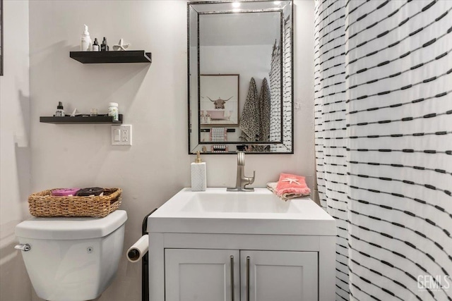 bathroom featuring vanity and toilet