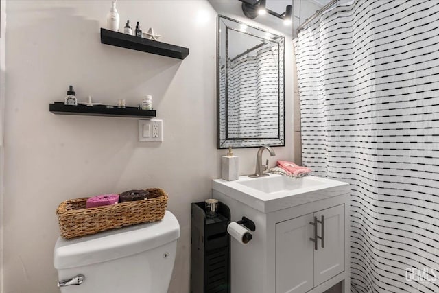 bathroom featuring vanity, a shower with curtain, and toilet