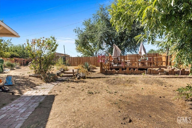 view of yard featuring a wooden deck