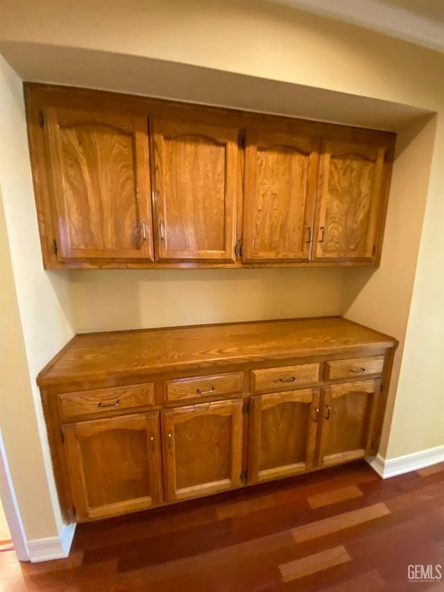 details featuring wood finished floors and baseboards