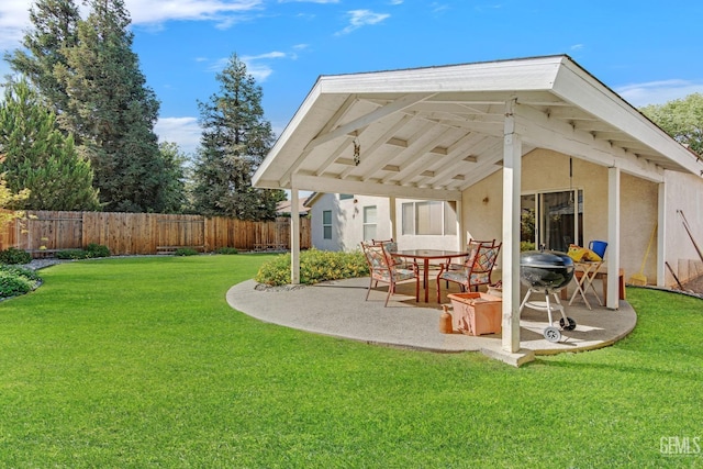 back of property with a lawn and a patio