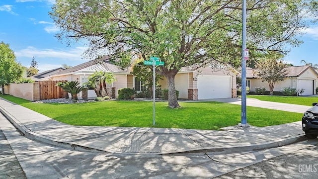 ranch-style house featuring a garage and a front lawn