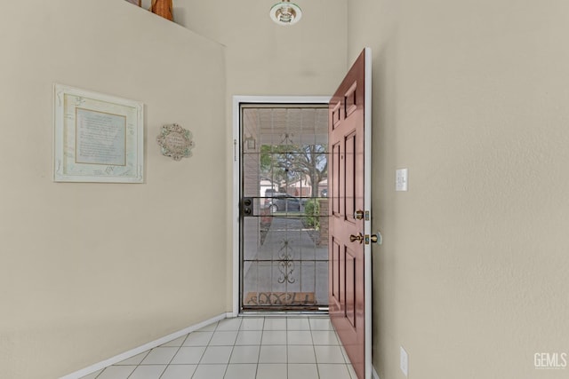 foyer entrance with light tile patterned flooring