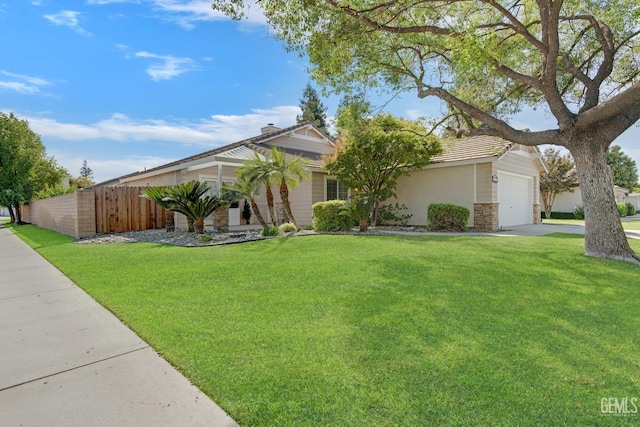 view of front of home with a garage and a front yard