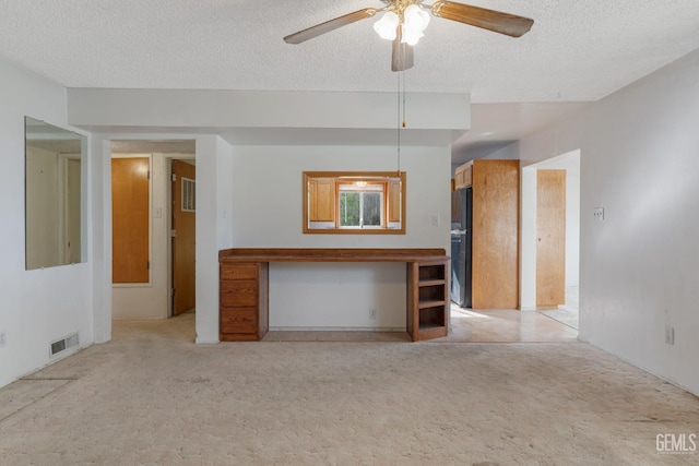 726 D St, Taft, CA 93268 - unfurnished living room featuring ceiling fan, carpet flooring, a textured ceiling, and visible vents
