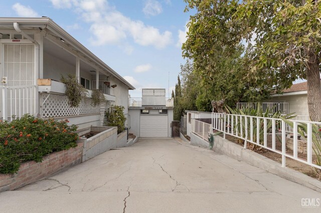 726 D St, Taft, CA 93268 - view of patio / terrace with fence, concrete driveway, and a garage