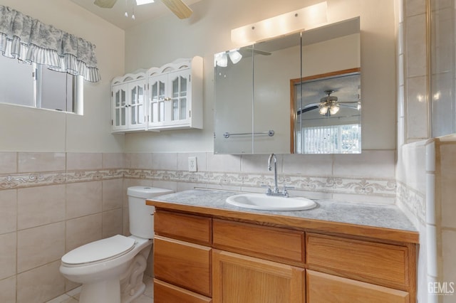 726 D St, Taft, CA 93268 - bathroom featuring tile walls, a ceiling fan, vanity, and toilet