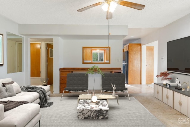 726 D St, Taft, CA 93268 - living room with ceiling fan and a textured ceiling