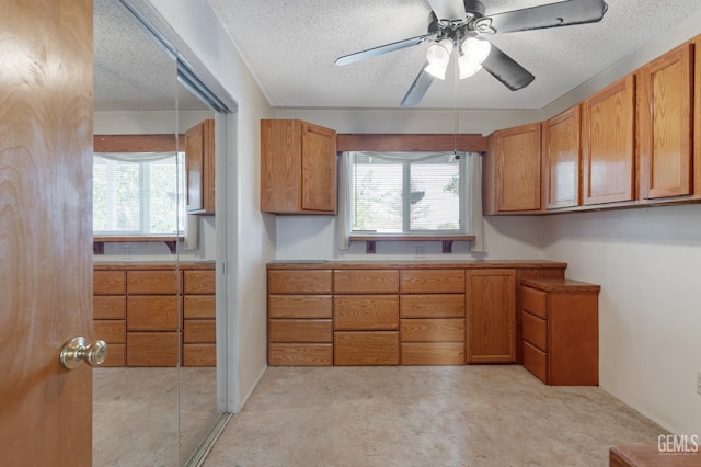 726 D St, Taft, CA 93268 - kitchen with light countertops, brown cabinetry, a textured ceiling, and a ceiling fan