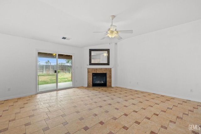 unfurnished living room featuring lofted ceiling, visible vents, a ceiling fan, baseboards, and a fireplace