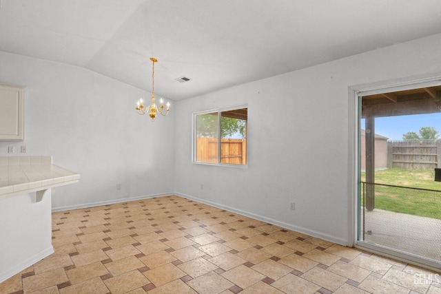 unfurnished dining area with a chandelier, lofted ceiling, visible vents, and baseboards