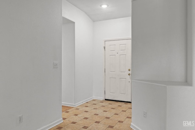 entrance foyer with baseboards and recessed lighting