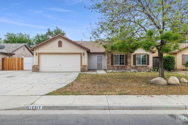 ranch-style home with driveway, stone siding, fence, a garage, and stucco siding