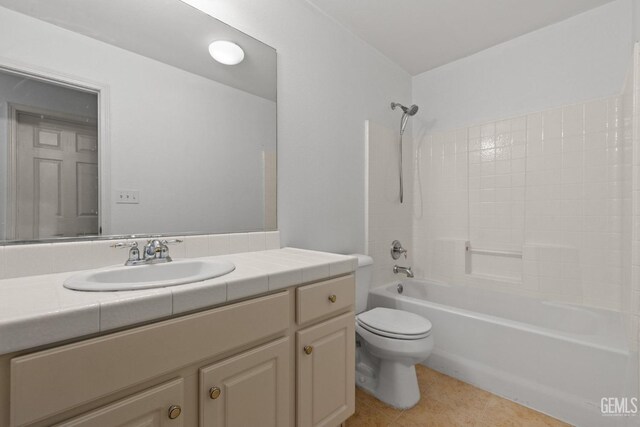 full bath featuring tile patterned flooring, toilet, vanity, and shower / bath combination