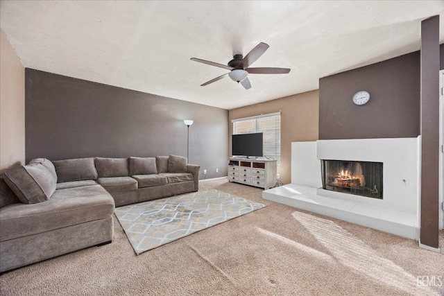 carpeted living room featuring a multi sided fireplace and ceiling fan