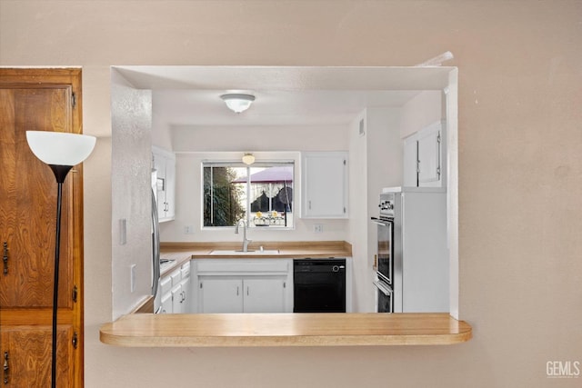 kitchen with stainless steel oven, dishwasher, sink, and white cabinets