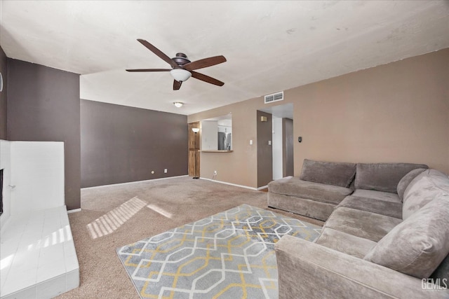 living room with ceiling fan and carpet flooring