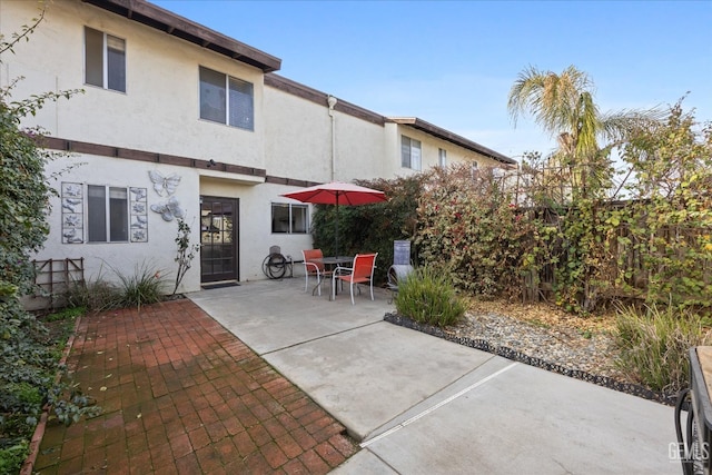 back of property with a patio