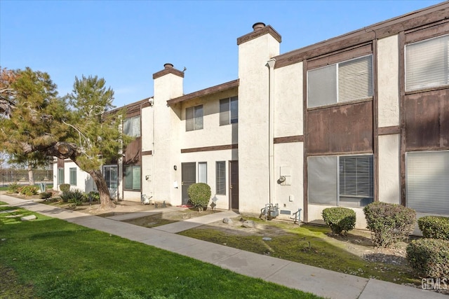 rear view of house with a yard