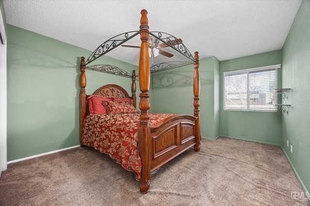 carpeted bedroom featuring ceiling fan and a textured ceiling