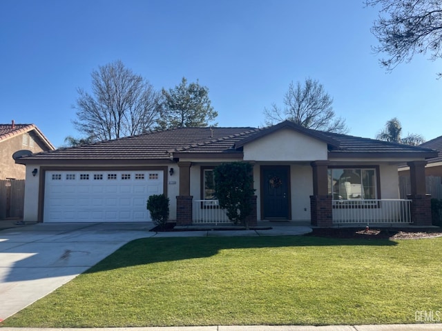 view of front of home with a garage, covered porch, and a front yard