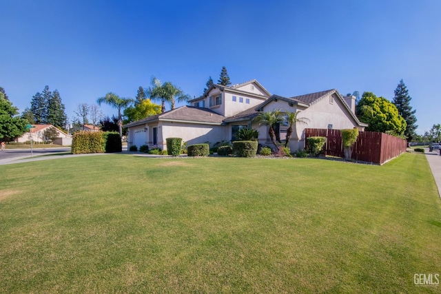 view of front facade with a garage and a front lawn