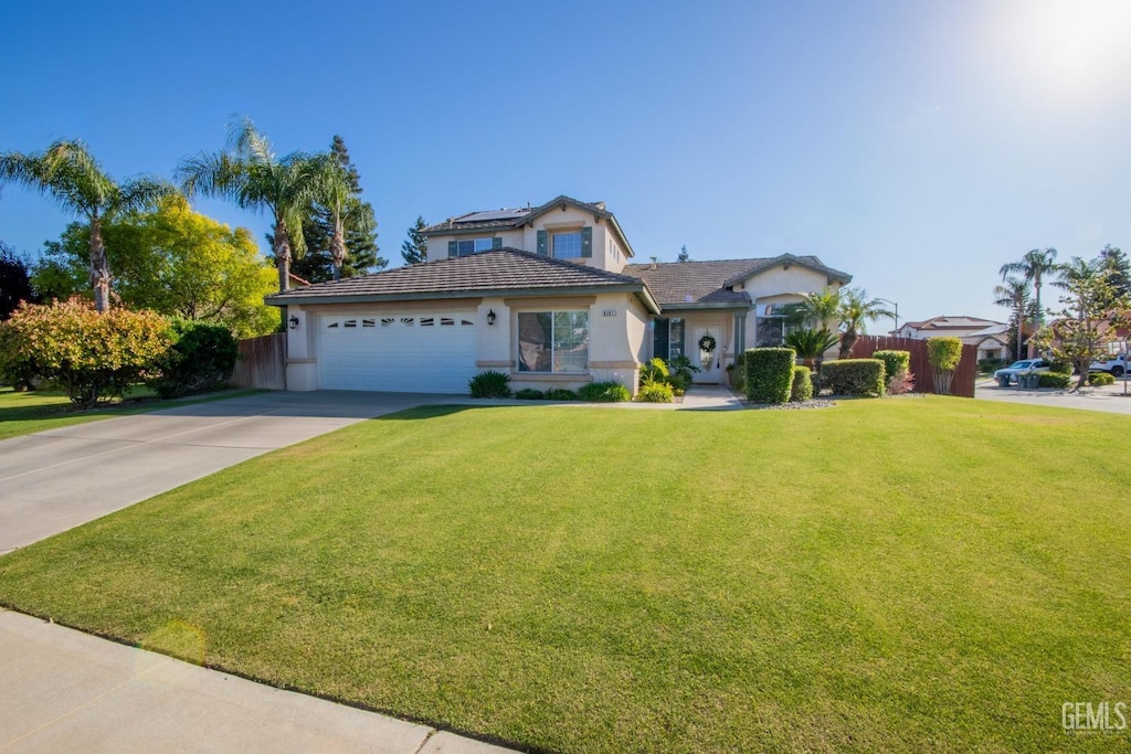 view of front facade with a garage and a front lawn