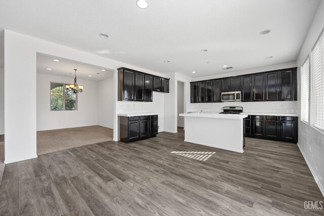 unfurnished living room with a chandelier and hardwood / wood-style flooring