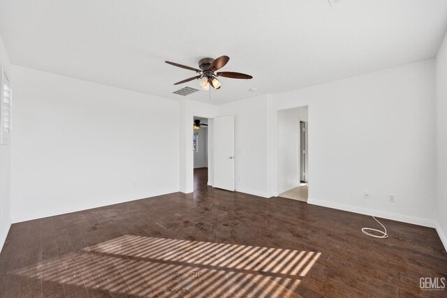 unfurnished living room featuring ceiling fan and dark wood-type flooring