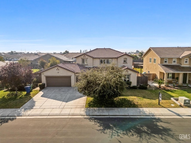 mediterranean / spanish-style home with a front yard and a garage