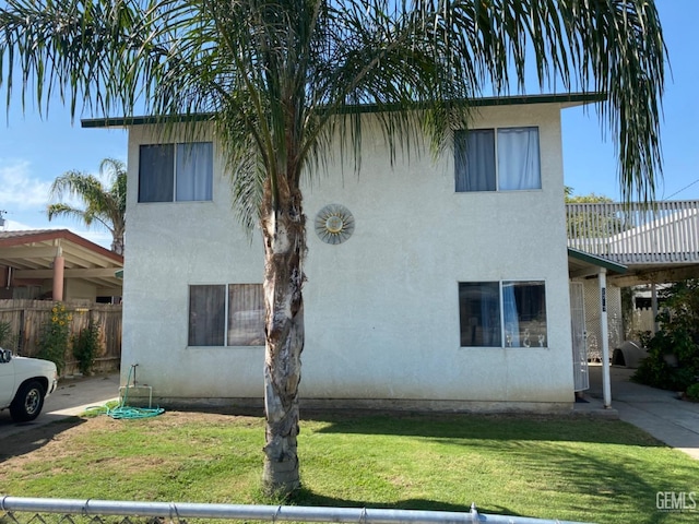 view of front of property featuring a wooden deck and a front yard