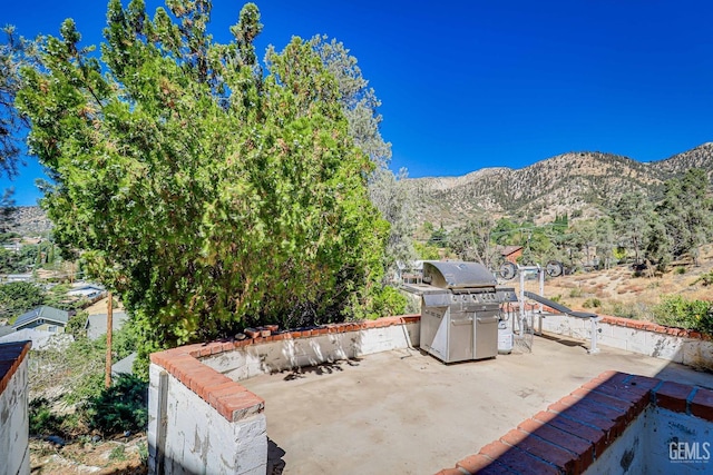 view of patio / terrace featuring area for grilling and a mountain view