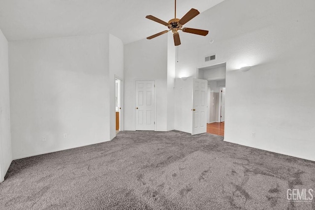 interior space with carpet flooring, high vaulted ceiling, ceiling fan, and visible vents