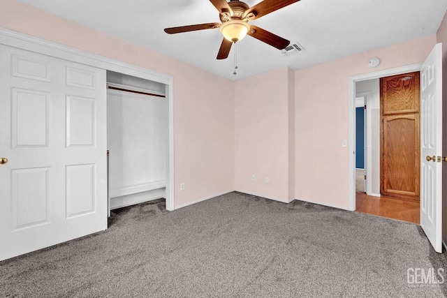 unfurnished bedroom featuring carpet floors, a closet, ceiling fan, and visible vents