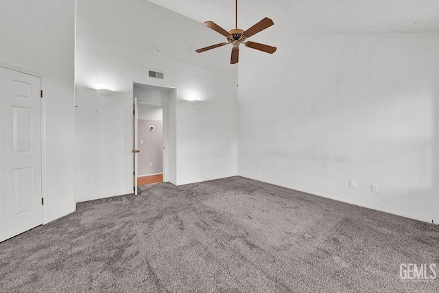 spare room with carpet floors, ceiling fan, and visible vents