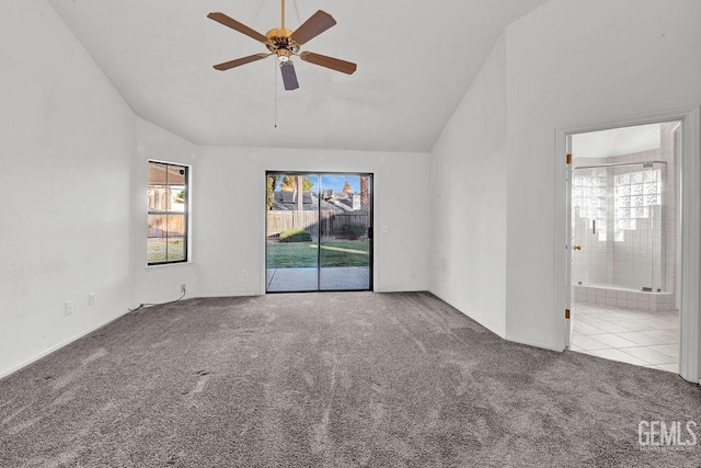 carpeted spare room with a ceiling fan, high vaulted ceiling, and a healthy amount of sunlight